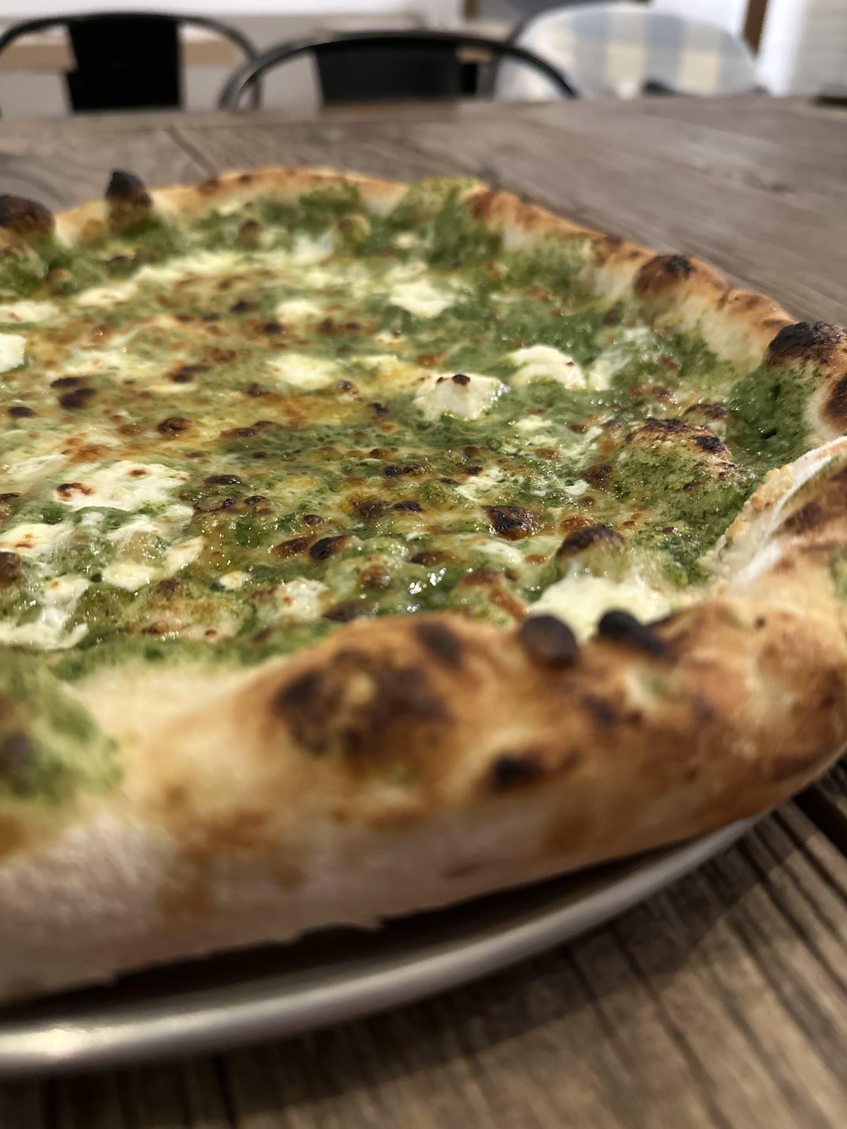 Green pesto wood-fired pizza at Tillage Pizza