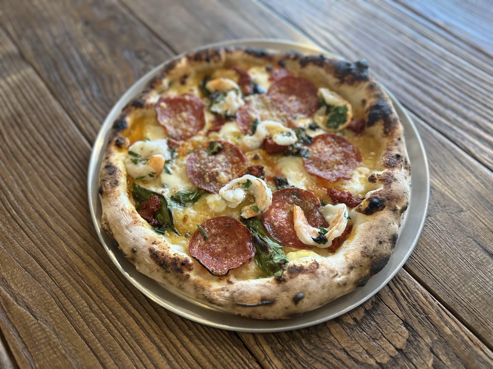 Wood-fired salami pizza at Tillage Pizza